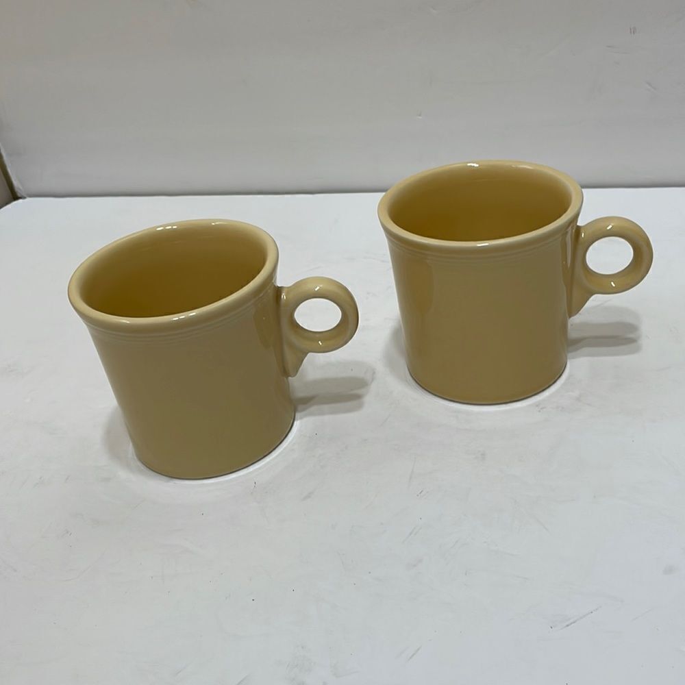 FIESTA HCL USA POTTERY MUGS IN PALE YELLOW. SET OF‎ TWO
